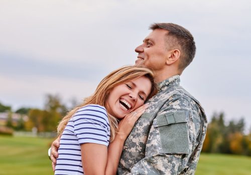 Married-soldier-hugging-wife-outdoor.-Woman-is-very-happy-her-husband-is-back-from-the-army